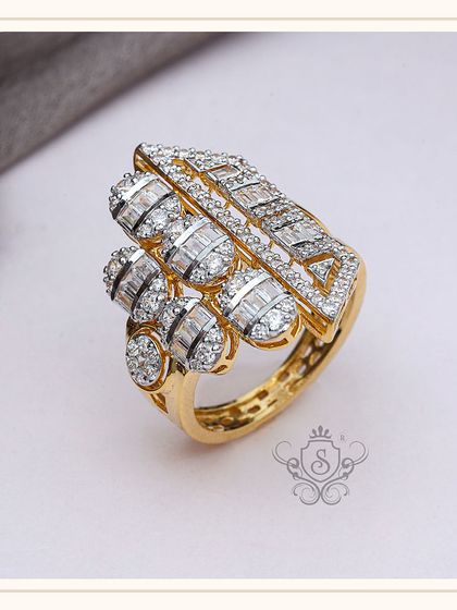 A modern and architectural diamond ring featuring both round and baguette-cut diamonds. The geometric design and multi-level setting create a powerful and sophisticated statement.