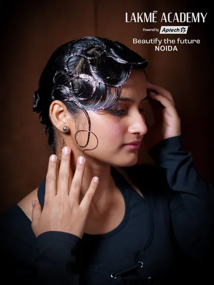 A sleek, wet-look hairstyle with glitter accents. This editorial style is part of our curriculum that prepares students for fashion and runway work.