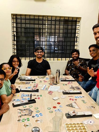 A team dives into the strategy of '7 Wonders: Architects' in our private meeting room, showing its versatility for both work and play.