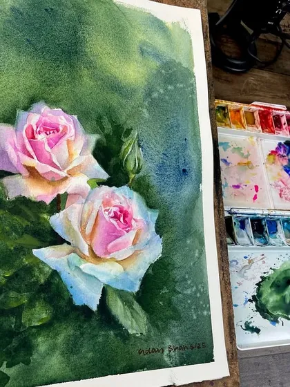 A slightly different angle of the rose painting, capturing the light on the paper and the vibrancy of the pigments.