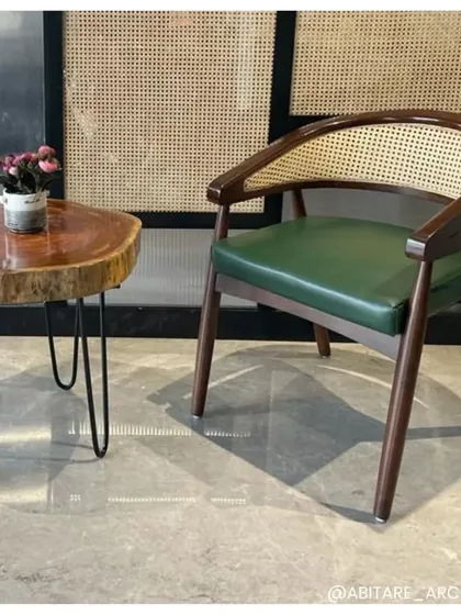 A close-up of a furniture pairing in one of our office projects. The natural-edge wood side table contrasts beautifully with the classic caned armchair, demonstrating our focus on selecting unique pieces that add character and texture.