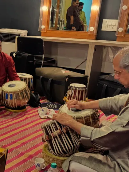 In the green room in Bangalore with Guruji. Even the moments before a concert are filled with learning, as he prepares himself and his instrument.