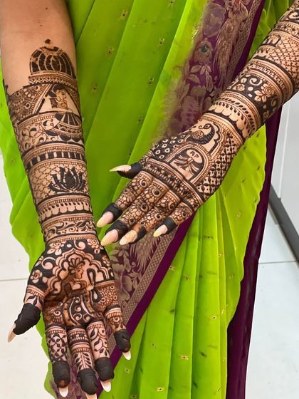 A close-up of a personalized design with a bride in a doli (palanquin) and other traditional wedding scenes.