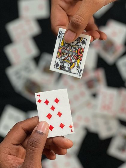 Two hands exchanging ceramic playing cards. This project started as a farewell gift and turned into something truly special.