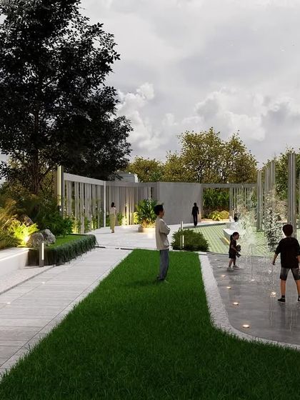 An interactive water feature with an illuminated spherical sculpture creates a playful yet sophisticated community space. The design combines lawn areas, paved paths, and integrated seating to encourage social interaction and activity for children and adults.