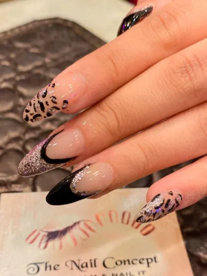 A bold and glamorous design on long stiletto nails. This set combines a black and glitter French tip with a fierce leopard print accent nail.