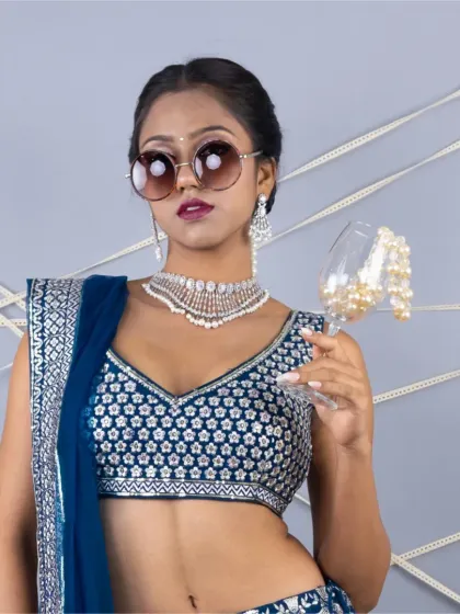 A close-up with a fun attitude, showing the heavily embroidered blouse and a beautiful diamond-like choker.