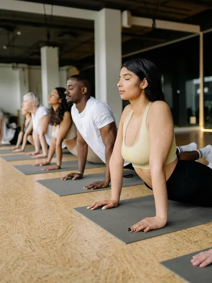 Become a certified yoga instructor and start your journey toward personal fulfillment. This image from one of our group classes shows the supportive community you will be a part of.