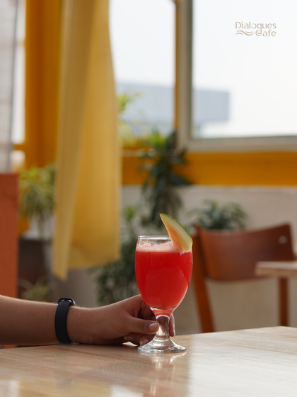 A glass of fresh watermelon juice against the warm yellow backdrop of our cafe. It's a simple, healthy, and delicious way to stay hydrated and energized.