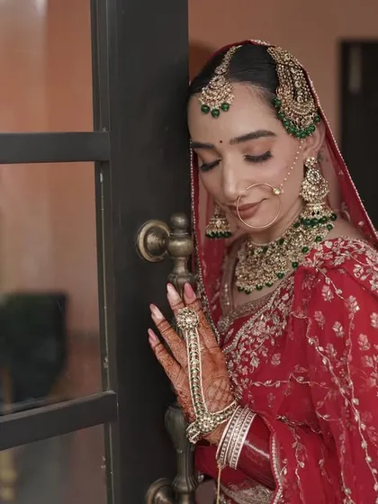 A serene bridal portrait. Her makeup is soft and glowing, creating a look of timeless beauty.