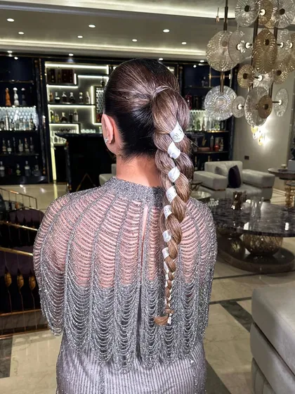 A detailed shot showcasing the texture and the precise wrapping of the ribbon in this braid.