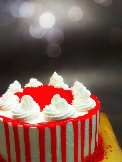 A beautiful red velvet cake with a striking striped icing effect. Our professional course covers a variety of modern decorating techniques to make your cakes stand out.