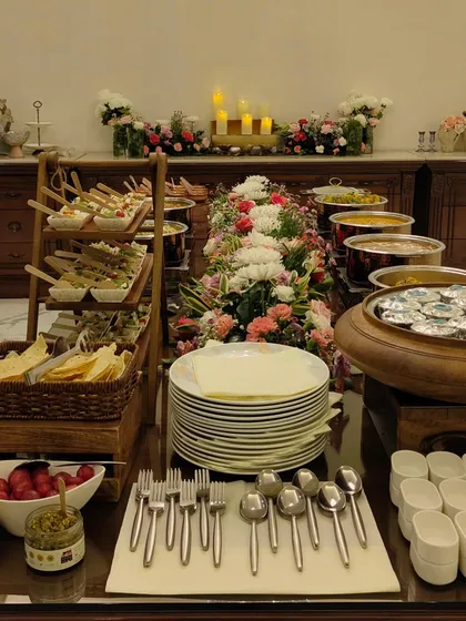 Another view of a stress-free Diwali celebration setup, with tiered appetizers and a full buffet ready for guests.