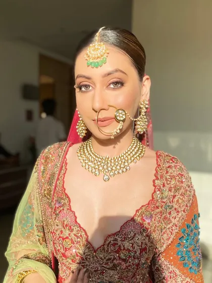 A close-up portrait that captures the essence of a sun-kissed glow. The makeup enhances her natural features, giving her a warm, radiant look that feels both effortless and regal.