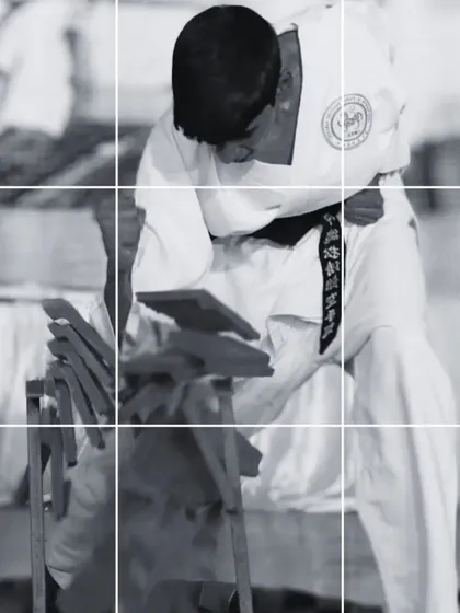 This black and white image captures the moment of impact, where focus and technique converge. Breaking is a mental exercise as much as a physical one, teaching students to overcome any challenge.