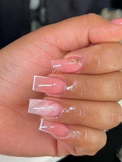 A stylish design featuring a pink sheer base with abstract white "marble" accents and a clean white outline on square nails.