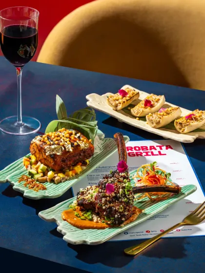 A full spread of modern Japanese grilled dishes from Harajuku Tokyo Cafe, including lamb chops and paneer skewers.