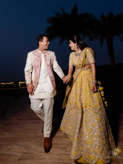 Styling for a sundowner engagement ceremony. The bride chose an unconventional chartreuse lehenga by Nidhi Tholia, and we styled the groom in a Jatin Malik couture open bandhgala with complementary ivory and pink tones.