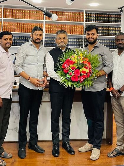 Holding a bouquet presented by friends on my birthday. I am grateful for the strong bonds of friendship that I have forged over the years.
