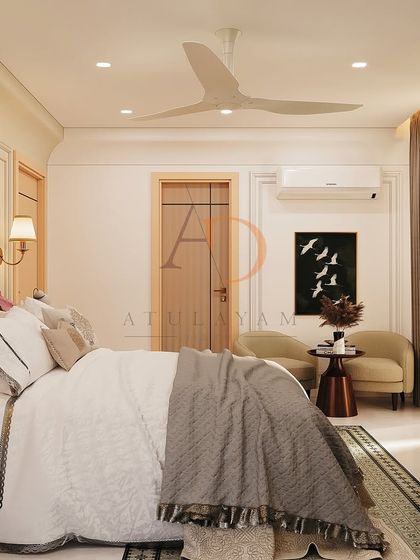 A side view of the bedroom, showing a cozy seating nook with a small sofa and artwork, creating a perfect spot for relaxation.