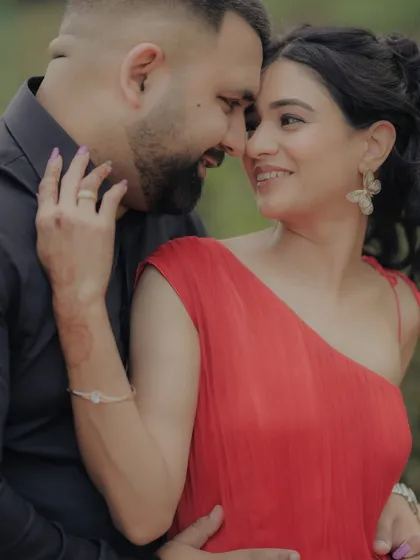 A close-up shot capturing the loving gaze between the couple. The woman's hand gently touching his face adds to the intimacy of this beautiful moment from their outdoor engagement shoot.