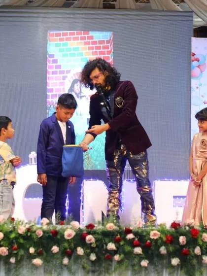 My magic shows are designed for the whole family. I love seeing the wonder on kids' faces as they become part of the magic on stage. This moment from a birthday party is a perfect example of the interactive, fun-filled experience I create.
