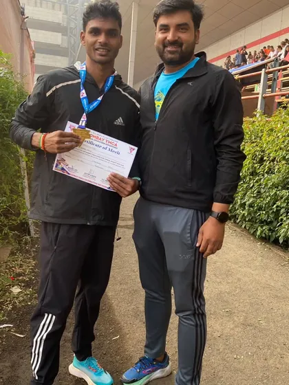 Posing with one of my champions after a successful competition. The certificate of merit is proof of his hard work.