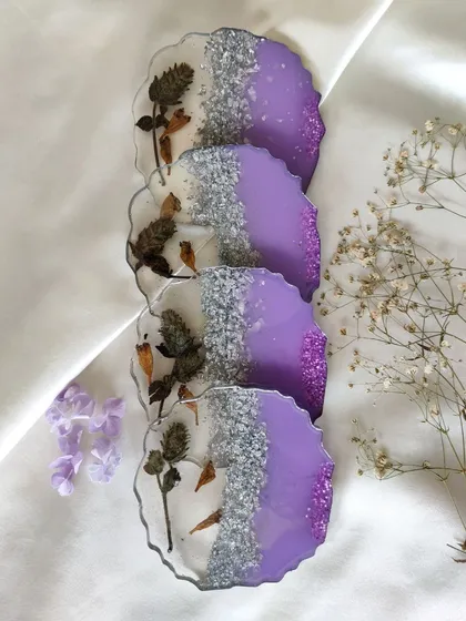 Here is a complete set of four custom agate-style coasters I made for a client. They wanted to preserve their special Neelakurinji flowers, so I paired them with a beautiful lavender purple base and sparkling silver glitter to make the blooms stand out.