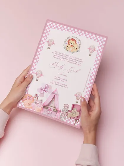 A heartwarming birth announcement for a baby girl. This printed card is filled with pastel charm, from the pink checkered border to the delicate illustrations of a nursery, celebrating a beautiful new beginning.