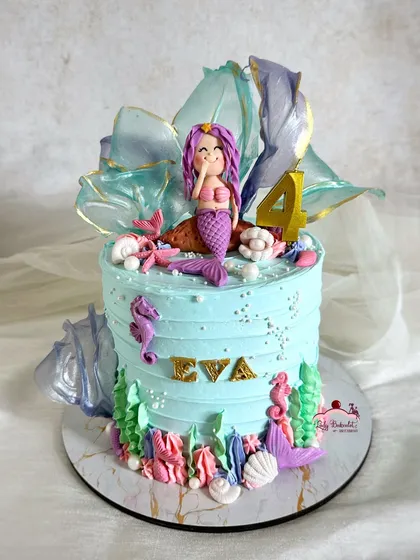 The mermaid cake on its own, featuring a hand-sculpted mermaid, rice paper sails, and lots of shimmering details.