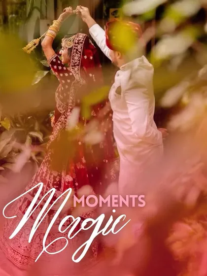 A candid, romantic shot of a couple dancing, framed by lush greenery and a touch of magical smoke.