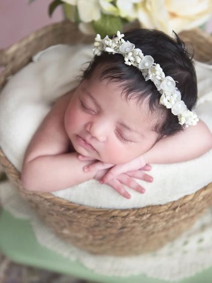 I love this simple and classic "chin on hands" pose. It's perfect for getting a beautiful close-up of your baby's face, from their delicate eyelashes to their tiny nose.