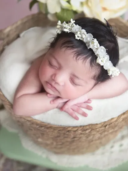 I love this simple and classic "chin on hands" pose. It's perfect for getting a beautiful close-up of your baby's face, from their delicate eyelashes to their tiny nose.