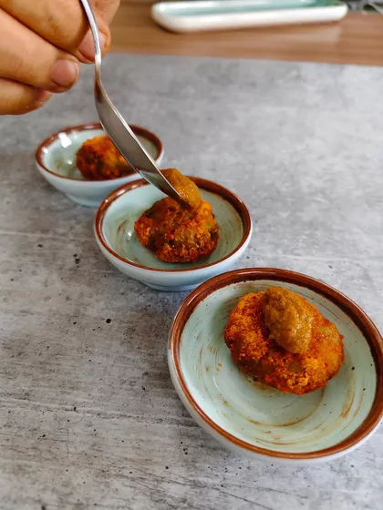 These aren’t your average fish cakes. We dust them in podi masala stardust, fry them to golden glory, and serve them with a side of pure spice love.