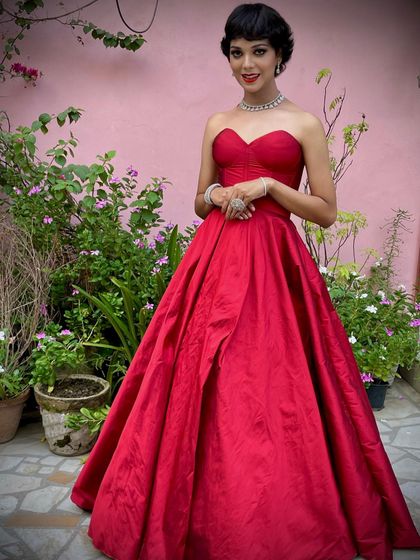 A full-length shot of the classic red ball gown. The rich color and timeless design make it a versatile piece for any formal occasion, ensuring you look and feel like a star.