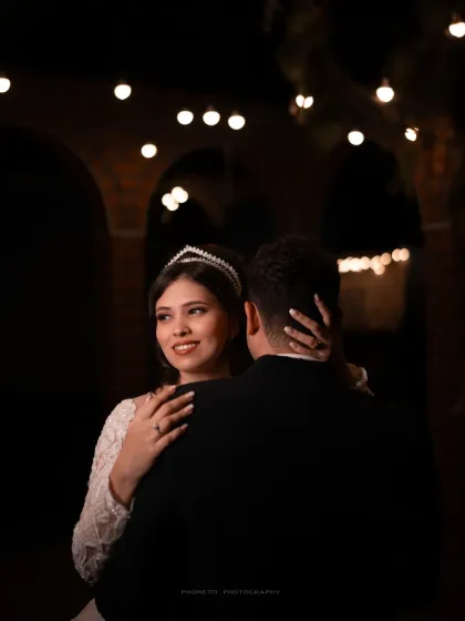 The bride looks back at her groom with a loving smile during their first dance as a married couple.