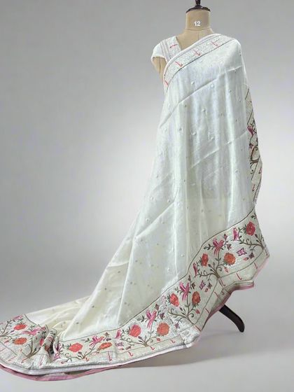 A full view of our tissue saree with a beautiful Paithani border, showcasing its elegant drape and intricate weaving.