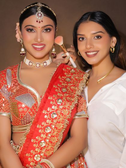 A behind-the-scenes moment with the artist and her model. This shows the final touches and the pride in creating a beautiful bridal look.