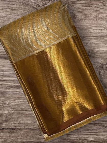 A rich brown Kanchi silk saree with a gold brocade pallu.