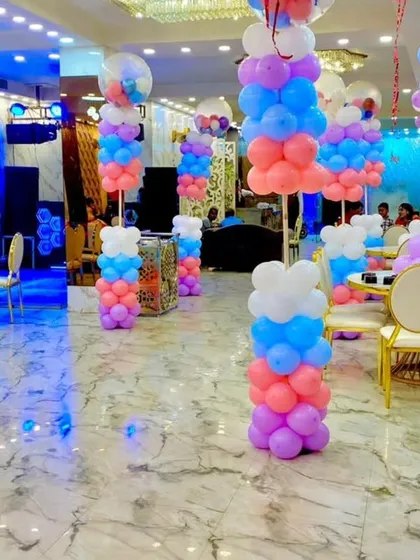 A wide-angle view of the butterfly-themed party hall. The pastel balloon pillars create a beautiful pathway, making the entire venue feel like a fairy garden.