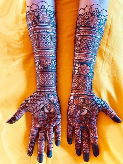 I have an obsession with floral elements, and this design shows it. The arms are covered in beautiful floral bands and peacock motifs, perfect for a bride who loves nature-inspired art.