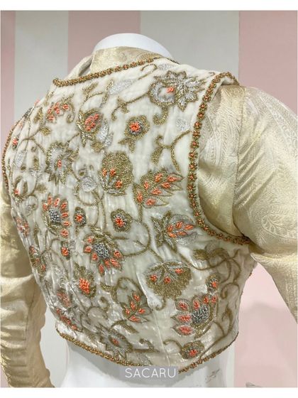 The back of the double-layered blouse, highlighting the dense floral embroidery on the velvet jacket.