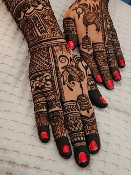 A close-up of the peacock and jhumka Diwali design, highlighting the fine lines and shading.