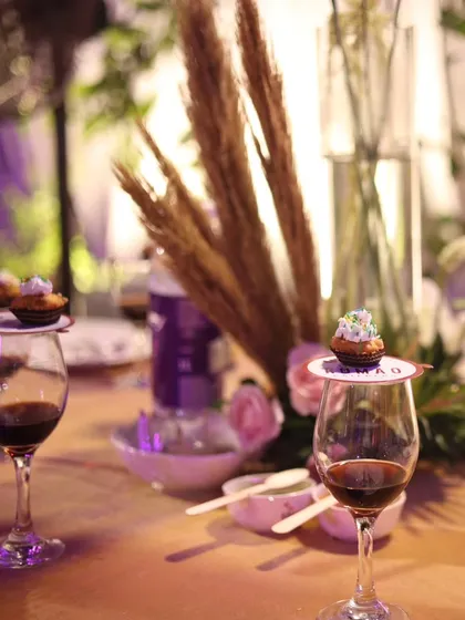 Another angle of an elegant table setting, featuring dried pampas grass centerpieces and custom dessert toppers, creating a modern yet reverent feel for a holy communion.