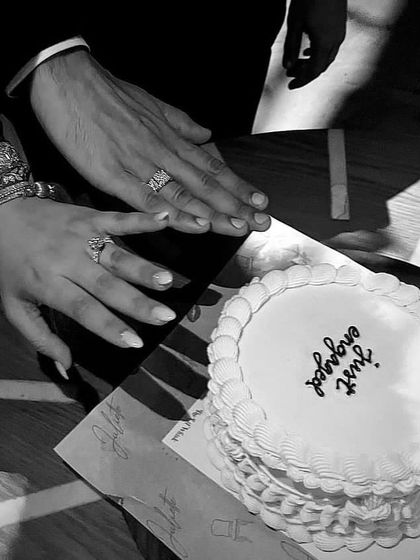 A simple and elegant "Just Engaged" cake. This black and white photo captures the beautiful moment, with the couple's hands and new rings displayed next to our cake.