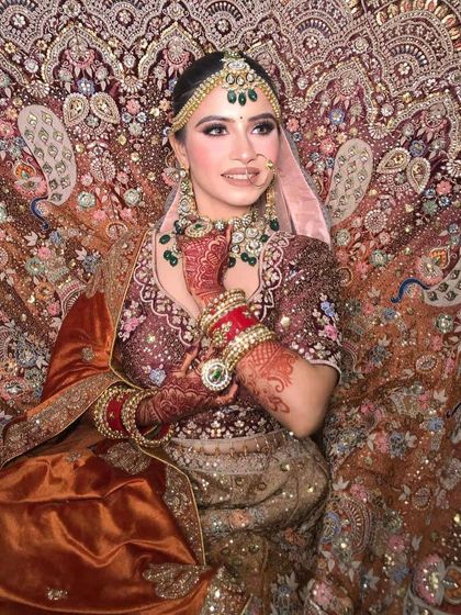 A happy bride posing in the magnificent peacock lehenga.