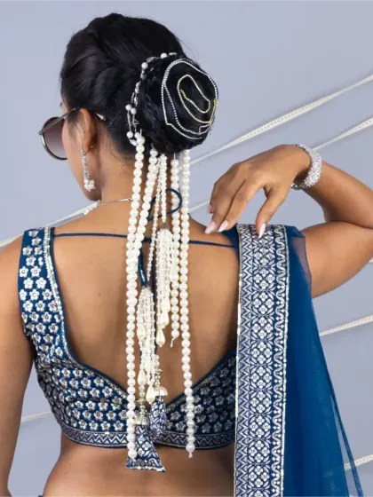 A detailed shot of the back, focusing on the unique pearl hair accessory that adds a touch of modern bridal style.
