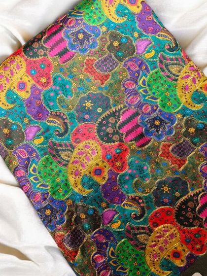 A close-up of the rich, jewel-toned printed silk, showing the depth of color and detail.