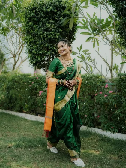 A stunning shot of a bride in a traditional Nauvari saree, ready for her wedding.