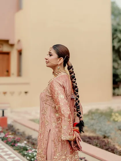 A portrait of the bride in her elegant pink sharara, a modern yet traditional choice for a Sikh wedding ceremony.